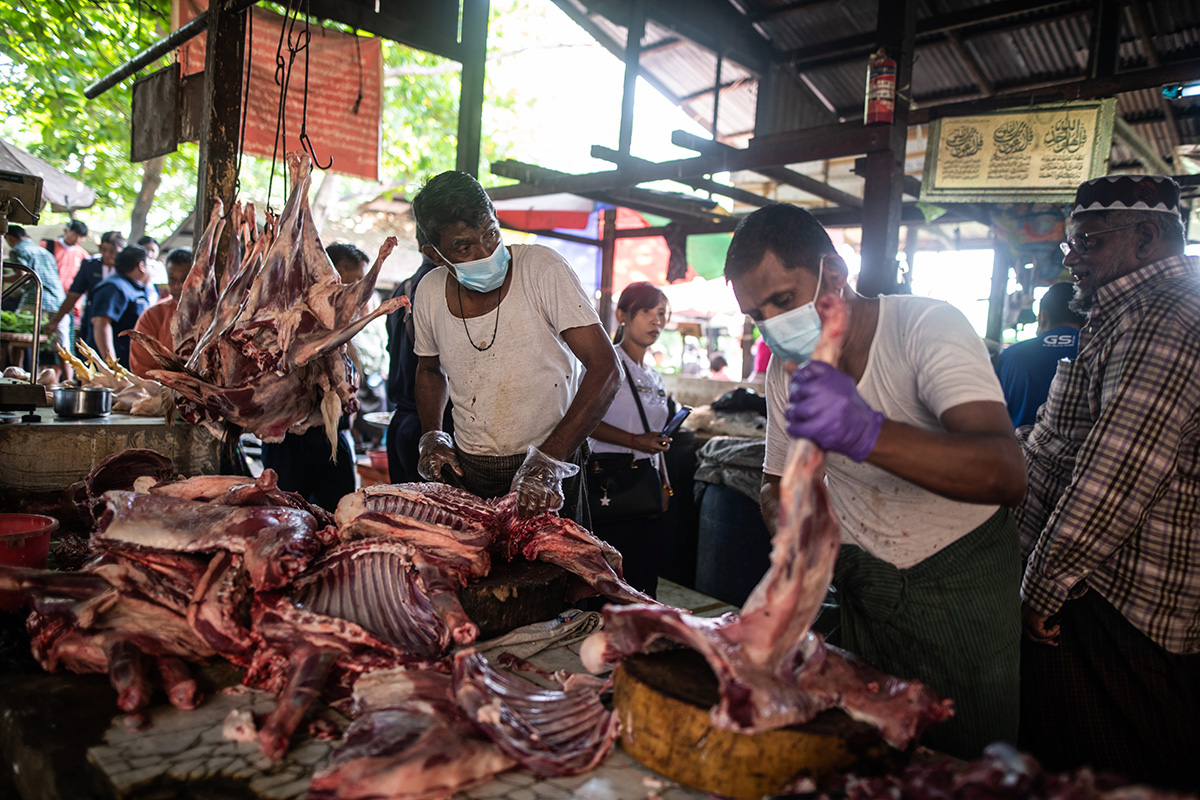 Vendor wearing face mask, amid concerns of the COVID-19 coronavirus, chop meat at a market in Yangon on March 21, 2020. (Photo by Shwe Paw Mya Tin/NurPhoto via Getty Images)