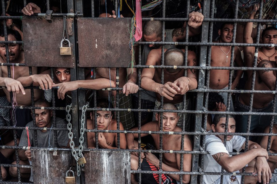 SAN SALVADOR, EL SALVADOR - MAY 20: MS-13 gang members languish in one of the three 'gang cages' in the Quezaltepeque police station May 20, 2013 in San Salvador, El Salvador. These overcrowded, 12x15 cages were designed to be 72-hour holding cells for common criminals and the two rival gangs, but many of the individuals have been imprisoned for over a year. (Photo by Giles Clarke/Getty Images.)