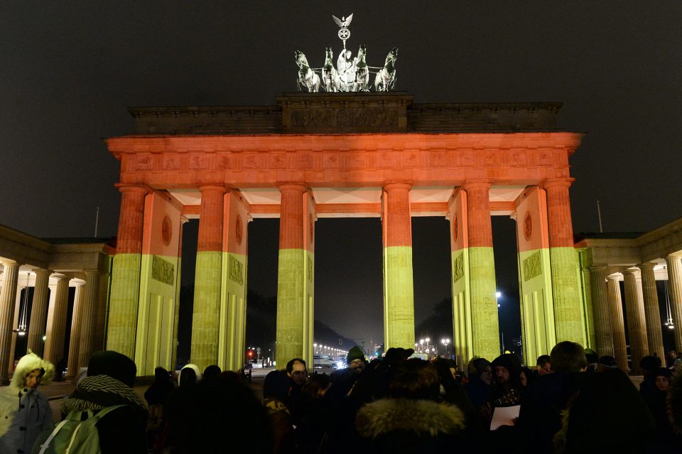 BERLIN, GERMANY - December 20: The Brandenburg Gate (Brandenburger Tor) is illuminated in black, red and gold, the colors of the German Flag to pay tribute to the victims of the attack on a Christmas market in Berlin, Germany on December 20, 2016. At least 12 people were killed and 48 others injured when a truck crashed into a crowded Christmas market in the German capital. (Photo by Maurizio Gambarini/Anadolu Agency/Getty Images)